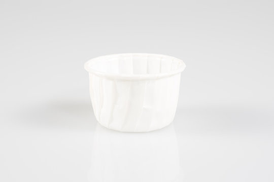 empty paper cupcakes cases on white background