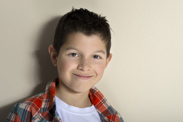 Portrait of a happy schoolboy isolated on a studio background