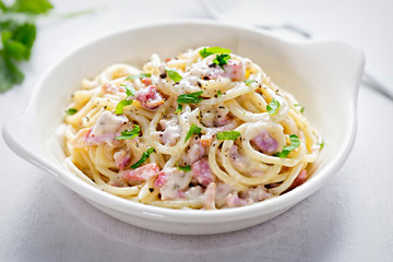 Spaghetti carbonara with bacon and fresh parsley 