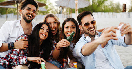 Happy young people taking selfies