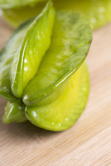 Closeup of carambola on wooden table.