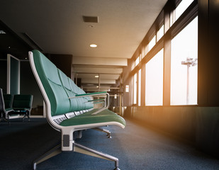 Row of empty chairs  in the airport at the morning