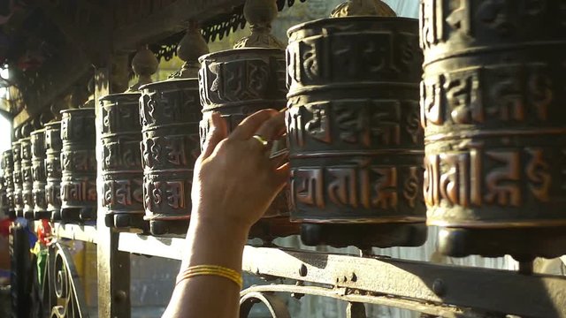 Spinning prayer wheels at the Swayambhunath Stupa, Kathmandu, Nepal.