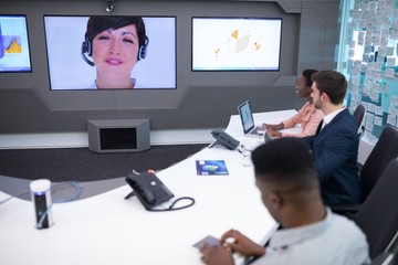 Male and female executives having video call