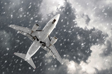 Airplane approaching on a landing in bad snow weather.
