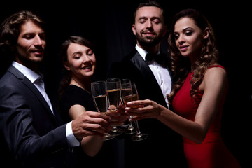 Cheerful people celebrating a sucess with Champagne