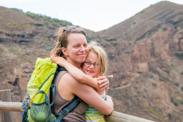 Mother is hugging her daughter after hike