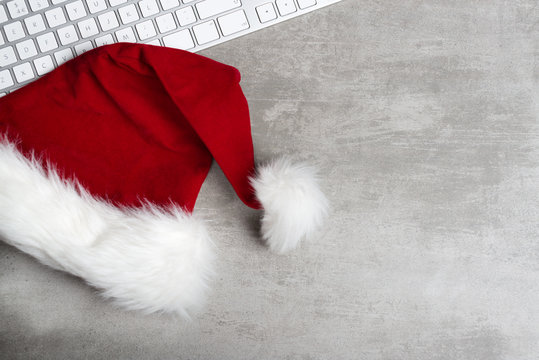 Red santa hat and computer keyboard - Powered by Adobe