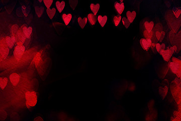 Valentine`s day abstract background with red hearts on a black background