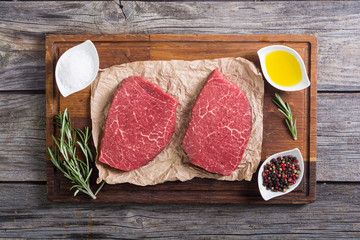 Raw beef steak with rosemary
