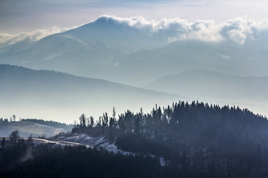 Fototapeta Dark winter Carpathian mountains in heavy clouds