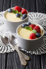 Healthy food: vanilla pudding with berries close-up. vertical