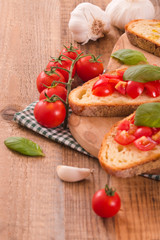 Bruschetta bread with basil and chopped tomatoes. 