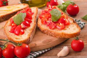 Bruschetta bread with basil and chopped tomatoes. 