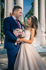 Lovely wedding couple kissing in the city