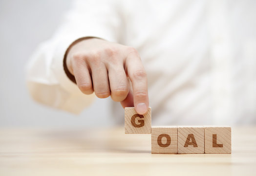 Hand and word Goal made with wooden building blocks