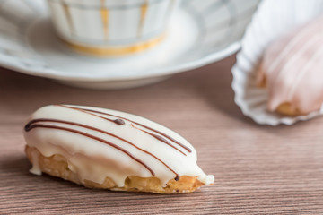 french eclairs on wooden table