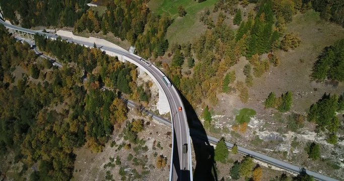 Truck on a alpine road, Cinema 4k aerial view following trucks driving on a mountain road, on a sunny fall day, on simplon pass, in wallis, of the alps in Switzerland