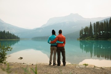 Hiker couple hugging near the lake