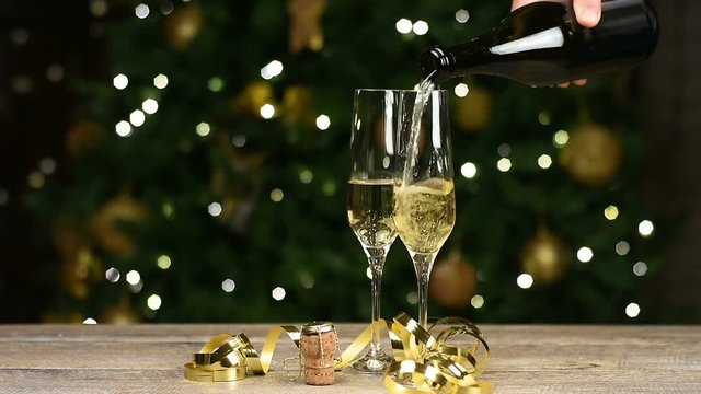 New year,  champagne poured on flutes, Candy cane, Christmas tree background