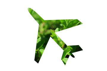 Silueta de un avión sobre fondo de hojas verdes.