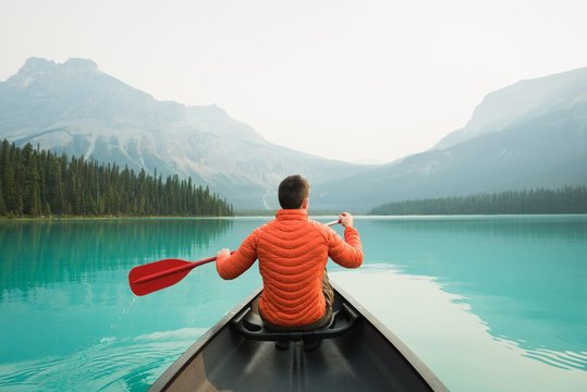 Rear view of man kayaking in lake