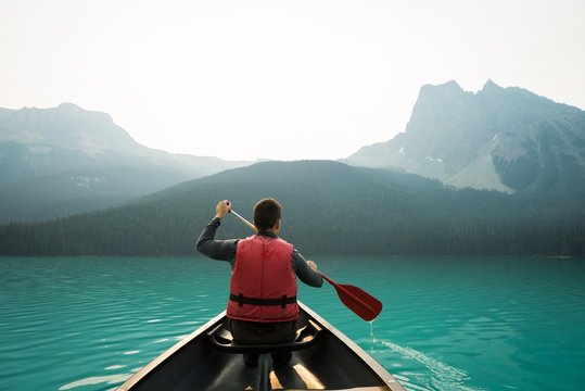 Rear view of man kayaking in lake