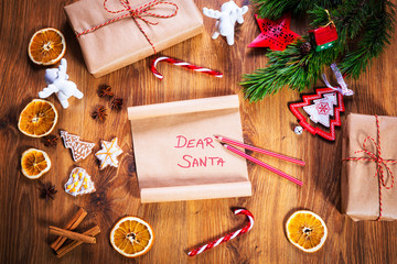 Christmas letter to Santa Claus on wooden table with christmas decorations