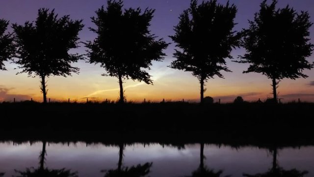 noctilucent clouds NLC over Noordhollandsch Kanaal canal summer twilight timelapse ZOOM OUT