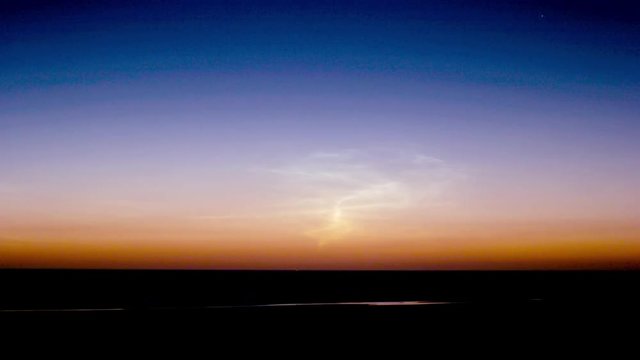 noctilucent clouds NLC over North Sea summer midnight twilight timelapse
