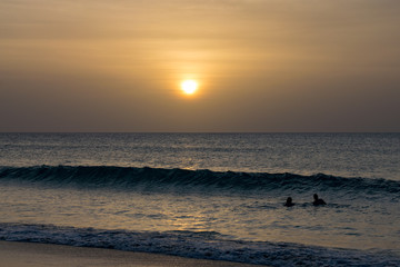 Fototapeta na wymiar Swimming in the ocean at sunset