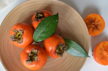 Delicious fresh persimmon fruit on wooden table health fruits