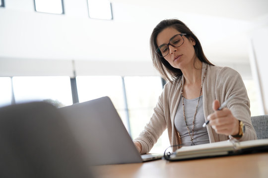 Woman in office working on laptop computer