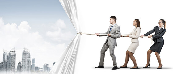 Young businesspeople working in collaboration and pulling white advertisement banner