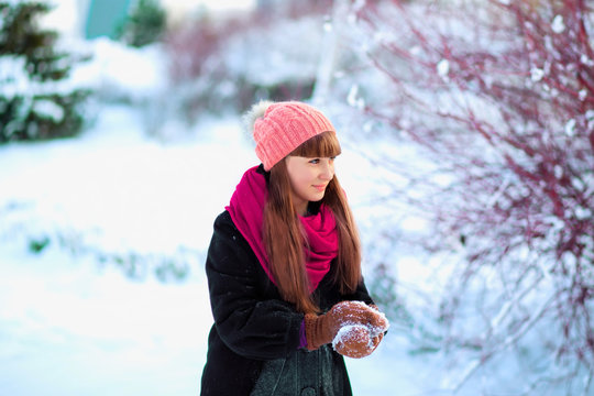 girl playing with snow