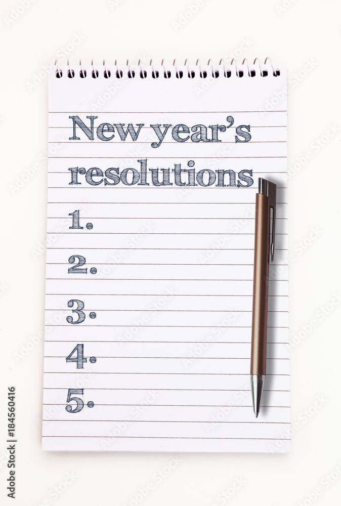 Poster top view of new years resolution written on notepad