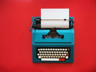 Top view vintage Typewriter on red background,copy space.
