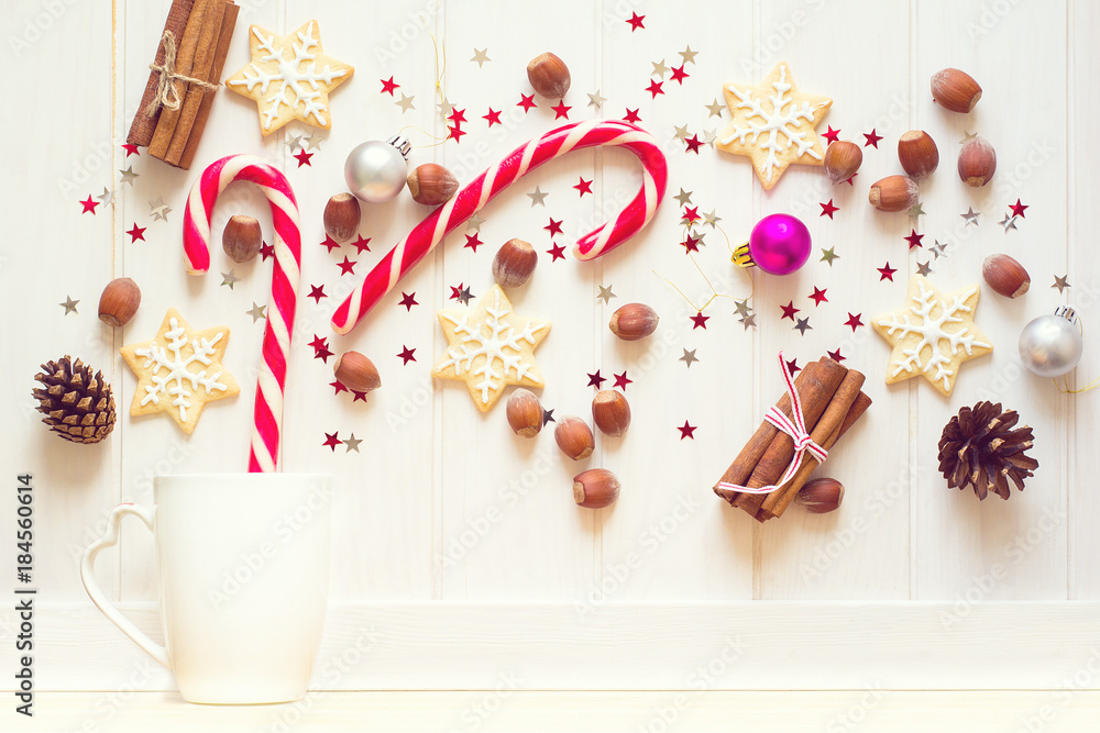 Sticker Christmas tea cup with gingerbread cookies and other sweets on white wooden background. Top view