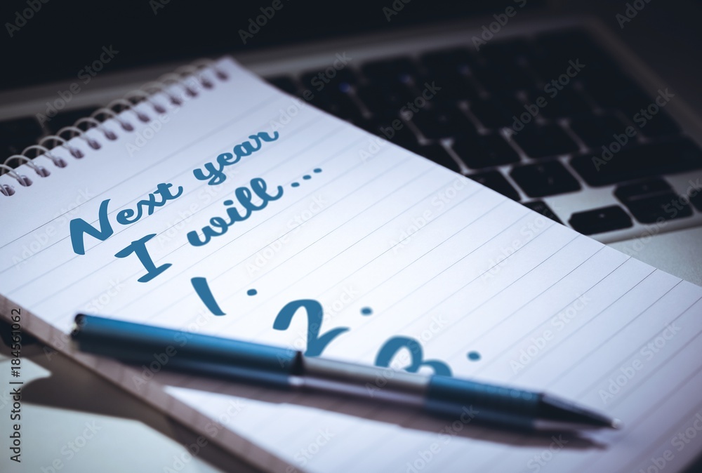 Poster top view of new years resolution written on notepad with pen on side