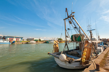 Fishing boats moored in harbor.