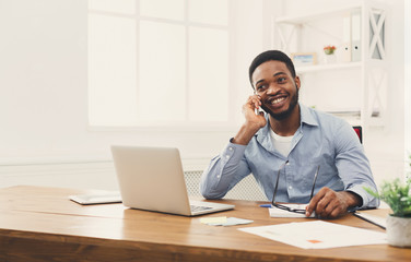 Young black businessman talking on mobile phone