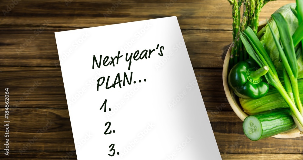 Poster top view of new years resolution written on notepad with bowl of vegetables on side