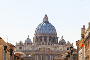 Fototapeta na wymiar View in perspective on the dome of Saint Peter Cathedrals Basilica in Vatican, via della Conciliazione, Rome