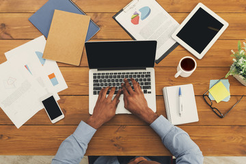 African-american businessman typing on laptop