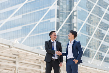 businessman being handshaking. in the background of city building office. Business deals concept.