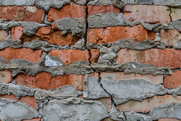 Detail of the cracked red bricks wall