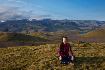 Fototapeta premium meditate on a background of mountains. Young woman alone with nature
