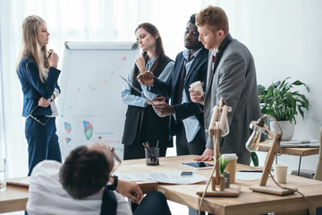 group of overworked managers having conversation at office