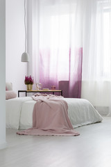 Pink blanket in cozy bedroom