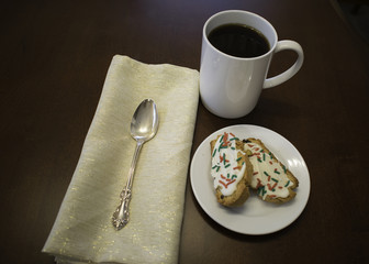 Place setting on table with cookies and coffee
